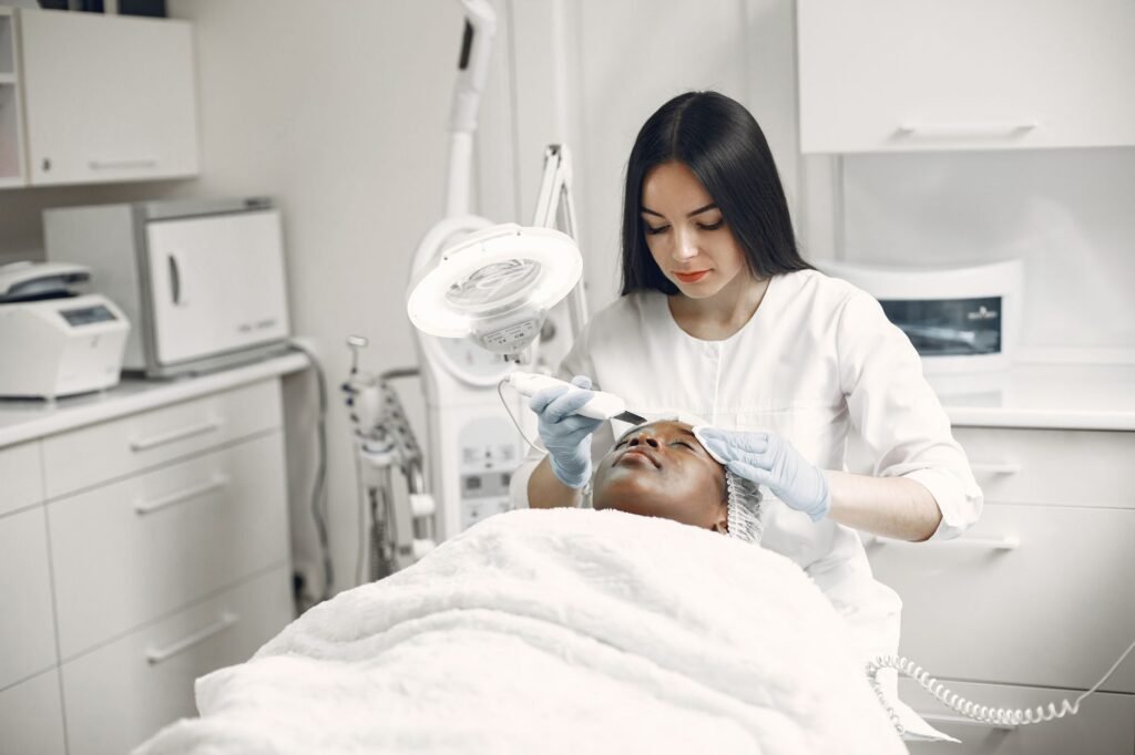 Aesthetician performing a professional microneedling treatment.
